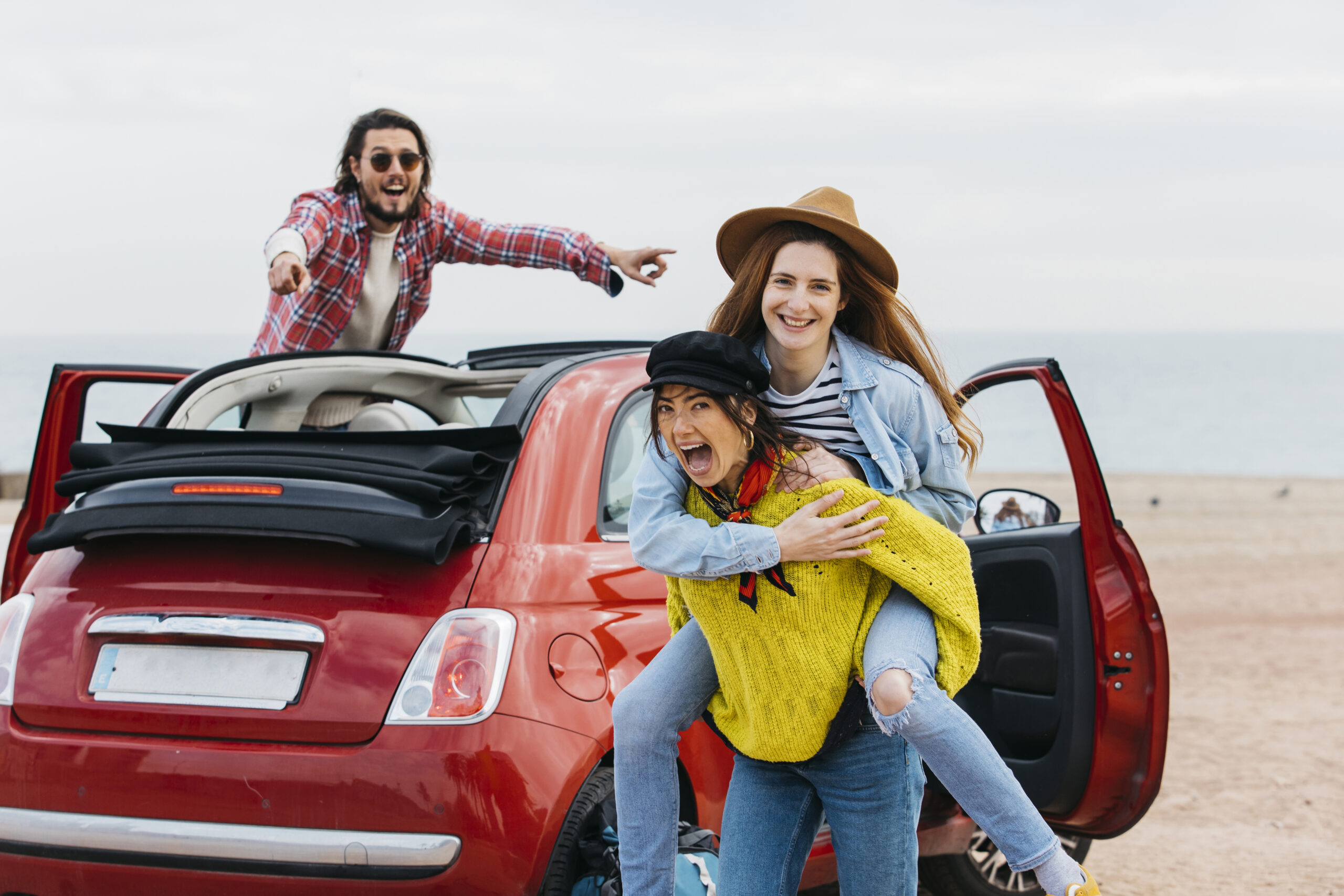 woman-holding-back-happy-lady-near-man-leaning-out-from-car